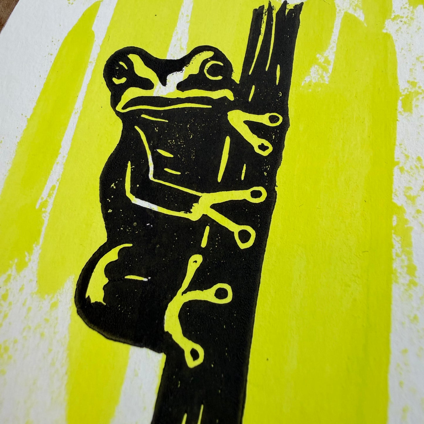 Close-up of the Pine Barrens Treefrog linocut showing hand-pulled black ink and painted background texture.